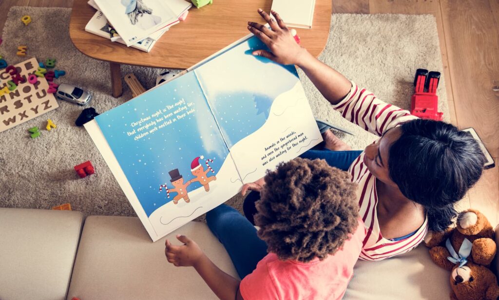 A woman reading a picture book wit her young son
Photo by: Rawpixel.com