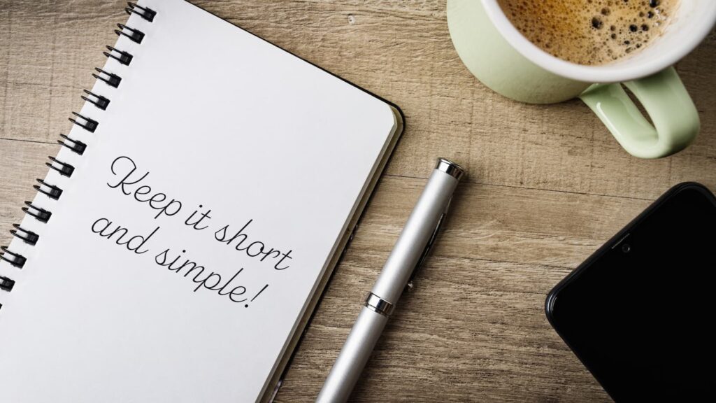A notepad with "Keep it short and simple!" written on it