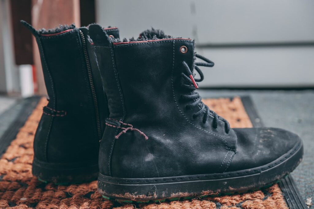 A pair of boots on a welcome mat