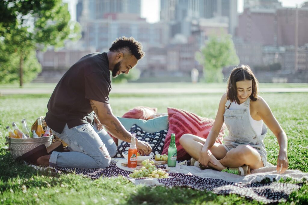 A couple enjoying a picnic in a park on a sunny day