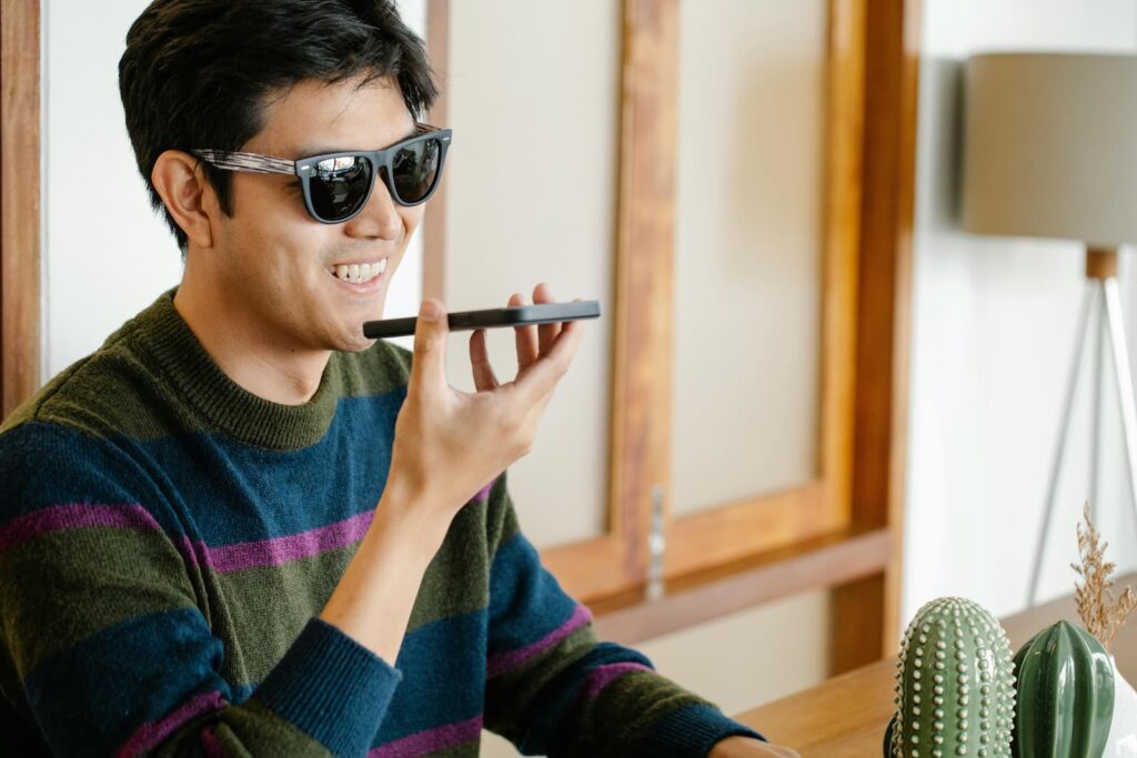 A man speaking into a smartphone to improve his English speaking skills