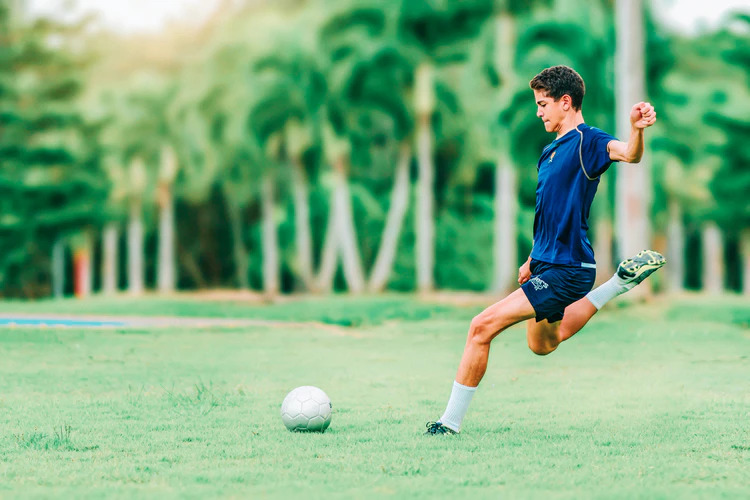 A player gets ready to kick a ball to “get it rolling”