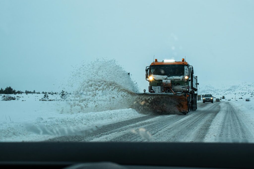 A snow plow removing snow from a winter road