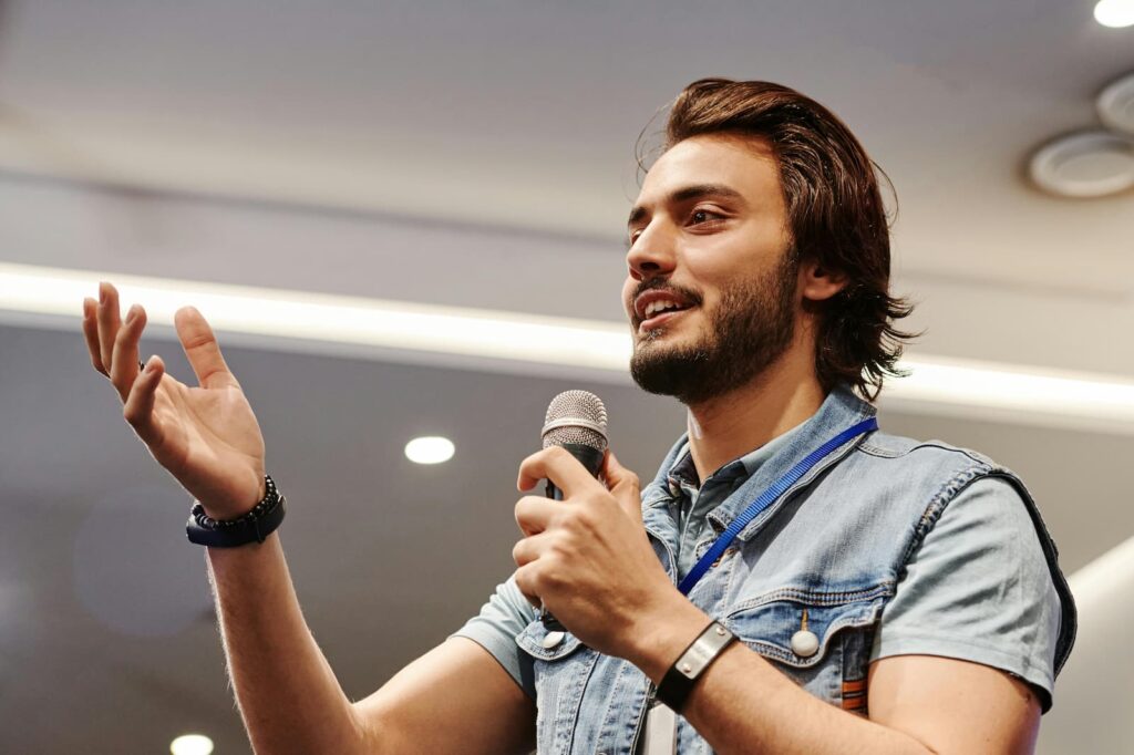 A young man speaking into a microphone