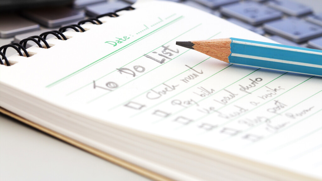 A pencil and a notepad with a To Do list written on it