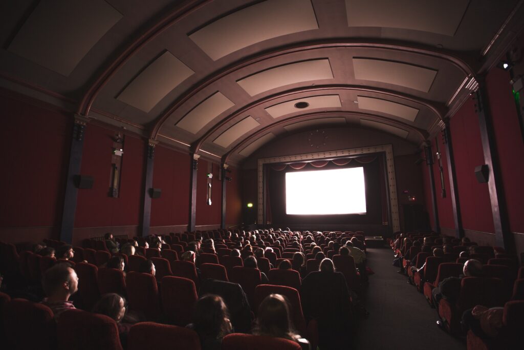 A crowd of people watching a film in a movie theater