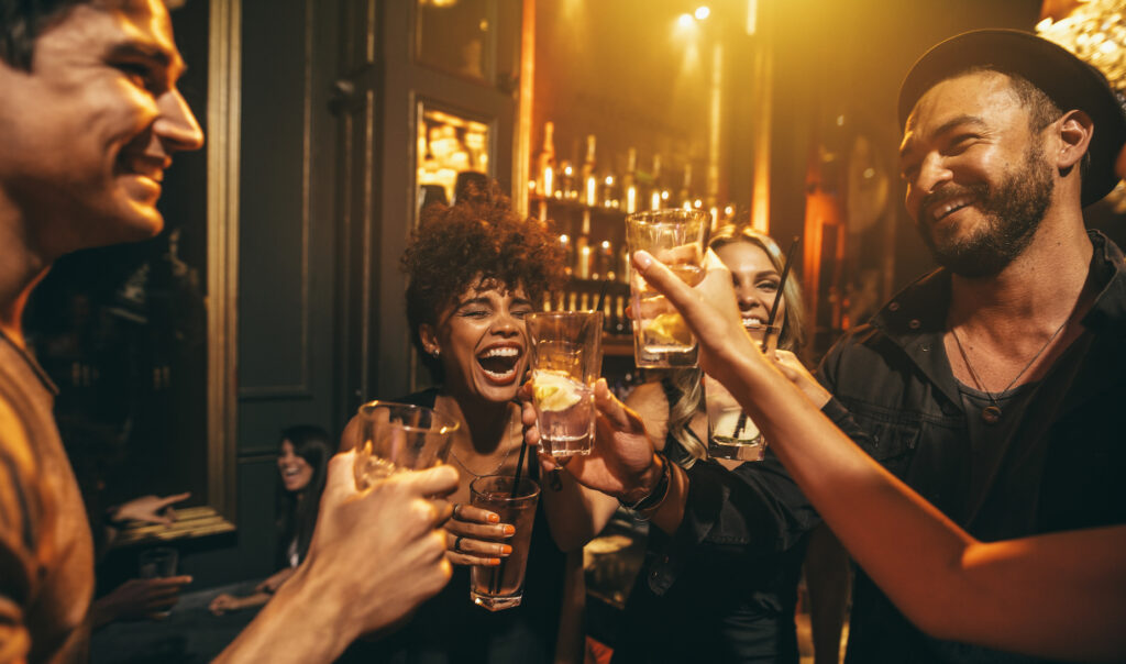 A group of people enjoying free drinks in a bar