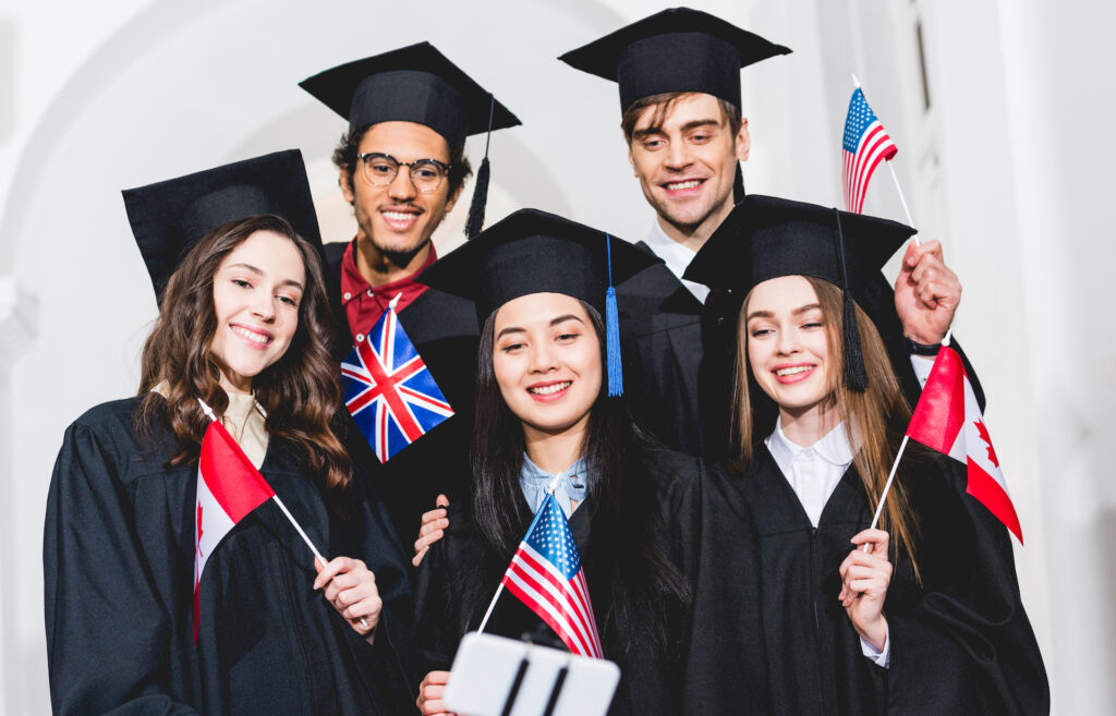 A group of students holding British, American and Canadian flags