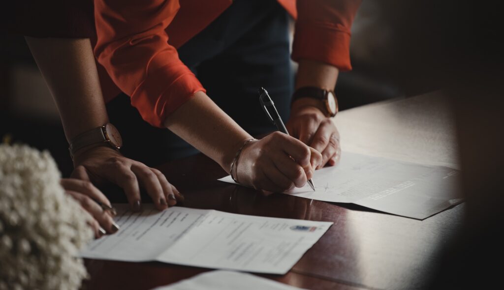 A person signing their name by the "x" on official documents