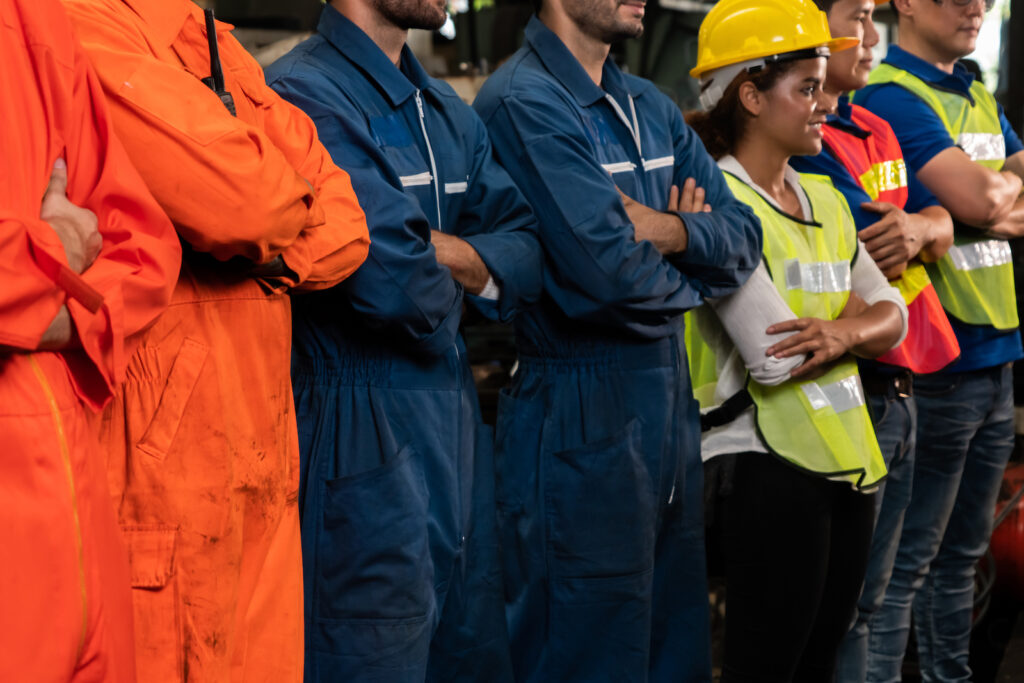 A group of union-member factory workers standing in a line
