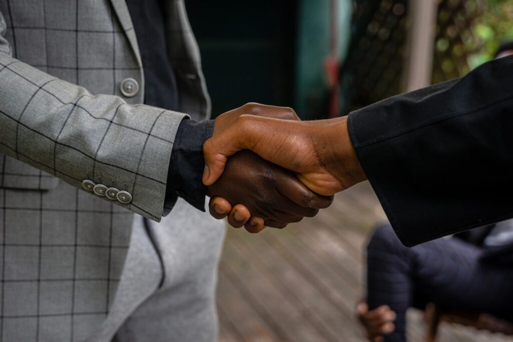 Two businessmen shaking hands after coming to an agreement