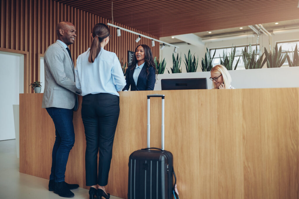 A couple checking in at a hotel's front desk