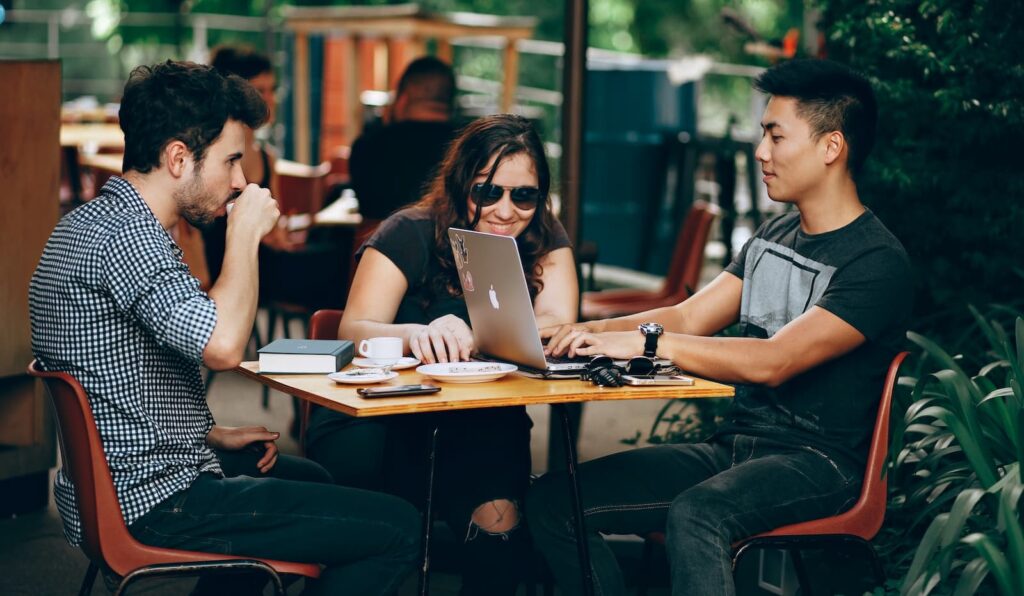A group of international friends studying at a cafe