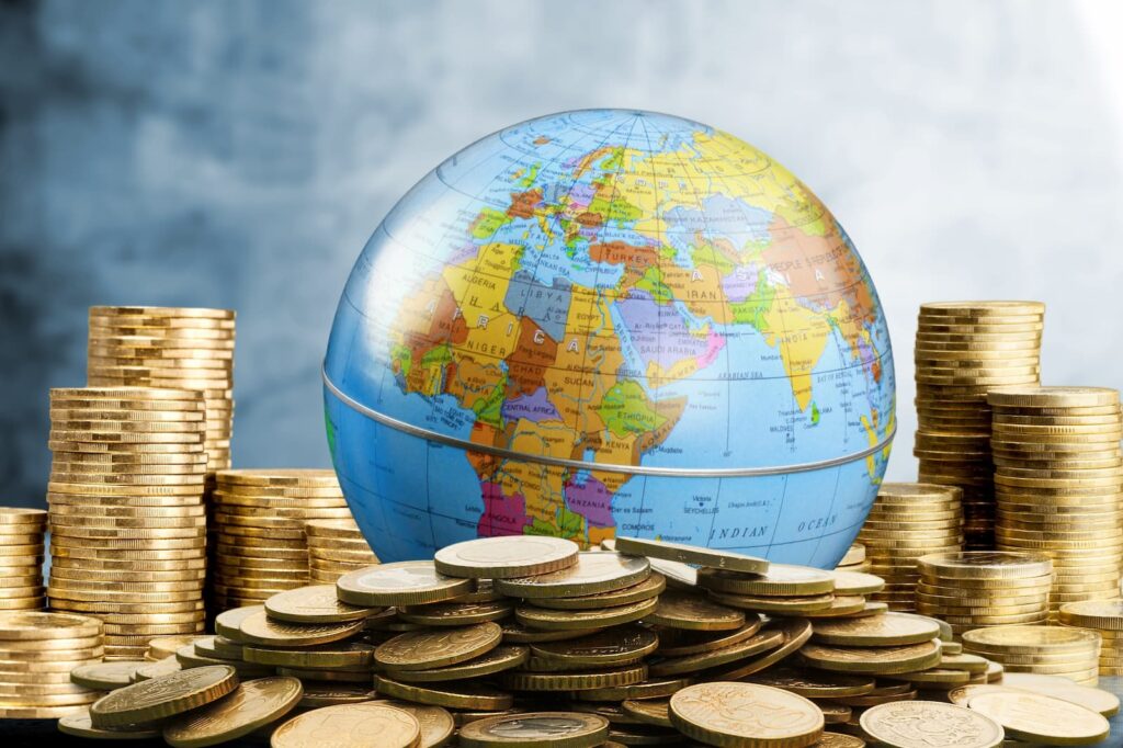 A globe surrounded by stacks of gold coins
