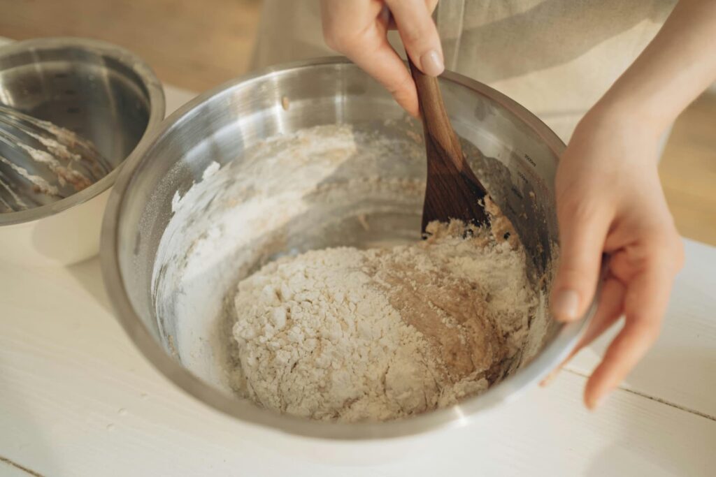 A woman mixing dough in a bowl