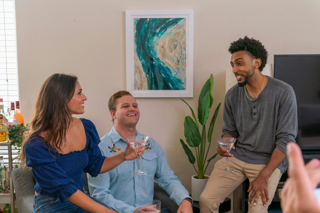 Three people chatting while at a casual party in someone's home