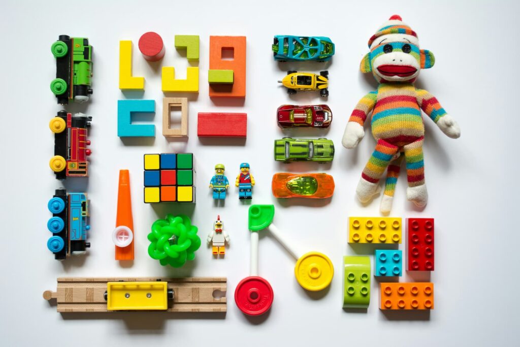 Various colorful toys arranged on a plain white background