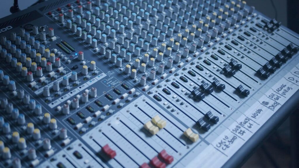 A large mixing console in a recording studio