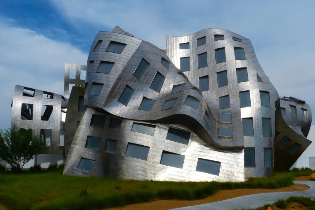 A silver building with several very unusual curving shapes