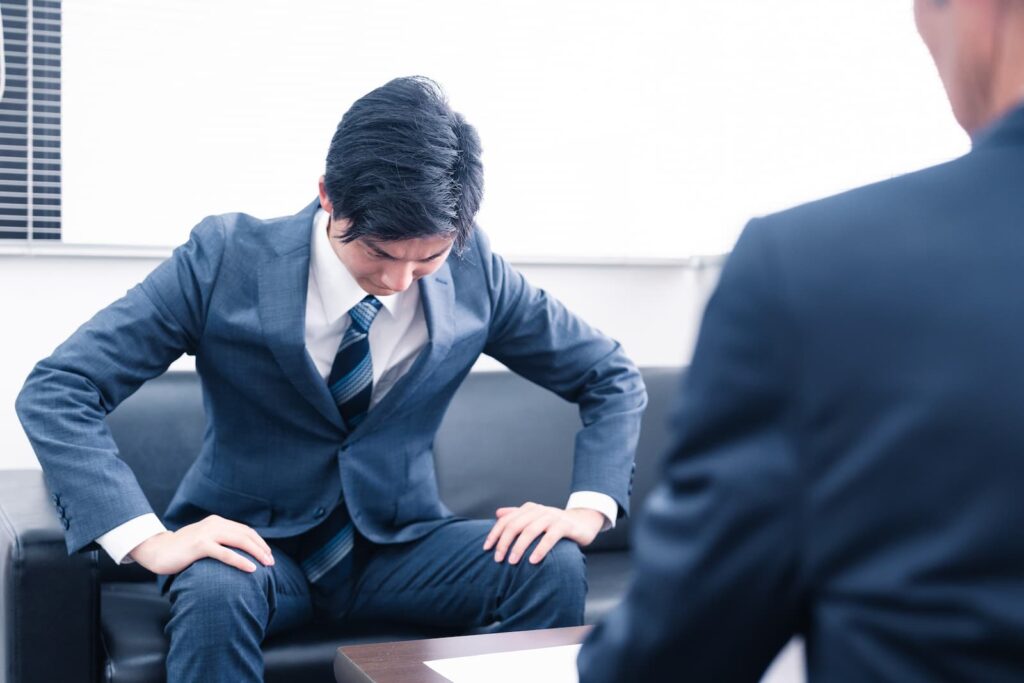 A young businessman bowing to show that he's sorry