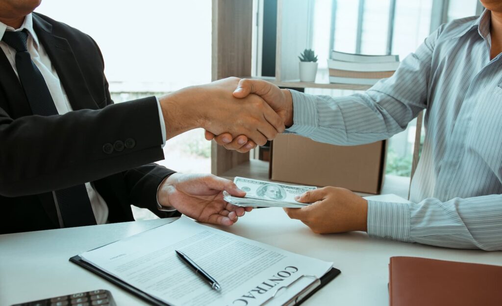 A banker lending money to customer in a professional office
